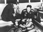 A cold water immersion experiment at Dachau concentration camp presided over by Professor Ernst Holzlöhner (left) and Dr. Sigmund Rascher (right). The subject is wearing an experimental Luftwaffe garment