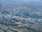 Aerial photograph of Nogales, Ariz. (lower left), the United States-Mexican border (diagonally from left to right), and Nogales, Sonora, Mexico (upper right).