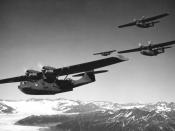 Four U.S. Navy Consolidated PBY-5 Catalina aircraft in flight over a glacier in the Alaskan coast, 22 August 1942. The wartime censor has tried to erase the squadron code on the first PBY, which appears to be 