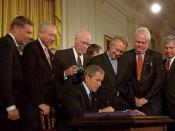 English: President George W. Bush signs the Patriot Act, Anti-Terrorism Legislation, in the East Room Oct. 26. 