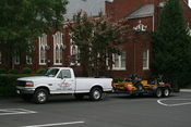 English: DJS Lawn & Landscape Ford F-250 XL pickup truck with lawn care equipment (riding mowers) on a trailer bed parked at Trinity Presbyterian Church in Durham, North Carolina.