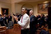 English: President Barack Obama, Vice President Joe Biden, and senior staff, react in the Roosevelt Room of the White House, as the House passes the health care reform bill.