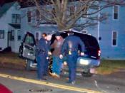 English: Police in Connecticut administer the one leg stand test to a driver after a crash. Photo was run through a paint daub filter to blur identifiable features of individuals