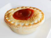 A typical Australian Meat pie with tomato sauce.
