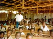 Teacher with students in Benin classroom