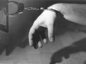 English: A man handcuffed to the handle of a loudspeaker.