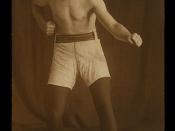 Photographic postcard of a boxer standing with clenched fist