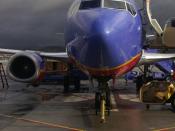 A Southwest Airlines Boeing 737 aircraft parked on the tarmac under cloudy skies at Bob Hope Airport in Burbank, California, United States.