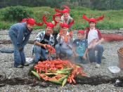 English: Capt. Brenda and kids wear lobster hats before eating lobster on an uninhabited island along the coast of Maine.