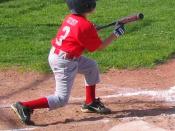English: A Little League baseball player squares around to bunt.