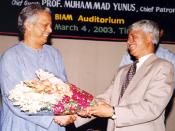 English: Mr. Ghulam Mustafa, President, Chittagong University Ex-Economics Students Association (CUEESA) presenting bouquette to Prof. Muhammed Yunus, Founder Managing Director of world-famous Grameen Bank and Micro-Credit Concept at BIAM Auditorium on Ma