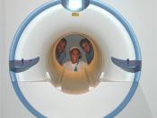 English: Osteoarthritis Initiative (OAI) researchers at Ohio State University look through the opening of an MRI machine, used to image the knees of patients. The OAI, a public-private partnership, led by NIAMS and the National Institute on Aging with add