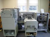 An on-demand book printer at the Internet Archive headquarters in San Francisco, California. Two large printers print the pages (left) and the cover (right) and feed them into the rest of the machine for collating and binding. Depending on the number of p