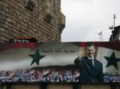 Billboard with portrait of Assad and the text God protects Syria on the old city wall of Damascus 2006