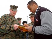 Marine Corps Sgt. Charles Heller, assigned to Blount Island Command, receives an autograph from National Football League (NFL) Hall of Famer Lynn Swann. Swann played for the Pittsburgh Steelers from 1974-1982. Twenty-two NFL Hall of Fame players visited t