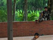 Begging, only money to think about - a child caring for a child in poverty, beautiful garden at জাতীয় স্মৃতি সৌধ Jatiyo Smriti Soudho Independence memorial park, Savar, Dhania, Dhaka, Bangladesh