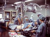 The image shows an operating room. A patient is being prepared for surgery.