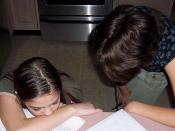 A mother and her homeschooled daughter, studying in the kitchen