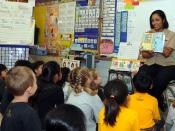 English: PEARL HARBOR (March 3, 2009) Boatswain's Mate 2nd Class Rasheema Newsome, assigned to Commander, Navy Region Hawaii, reads Dr. Seuss' The Cat in the Hat to kindergarten students at Lehua Elementary School. Students from kindergarten to sixth grad