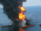 English: Platform supply vessels battle the blazing remnants of the off shore oil rig Deepwater Horizon. A Coast Guard MH-65C dolphin rescue helicopter and crew document the fire aboard the mobile offshore drilling unit Deepwater Horizon, while searching 