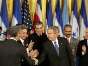 English: President George W. Bush shakes hands with legislators, administration officials and guests, Tuesday, August 2, 2005 in the East room of the White House, after the signing ceremony for the CAFTA Implementation Act.