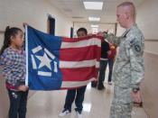 English: Amalia Pazreves, 10, and Milton Ramos, 11, sixth-grade Woodlawn Elementary students prepare to fold the Freedom Flag as Sgt. 1st Class Michael Moore explains its symbolism. The flag was created in Richmond in 2001 as a way of ensuring the events 