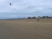 English: Kite Boarding, Romney Sands A brisk north westerly is propelling this young person along.