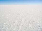 A photograph of the snow surface at Dome C Station, Antarctica, it is representative of the majority of the continent's surface. The photo was taken from the top of a tower, 32 m above the surface.