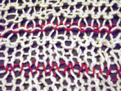 Knitted fabric illustrating the definition of a course. Two red courses are shown, the lower one being knitted in a stockinette stitch (top and bottom knitted), the upper one in garter stitch (bottom purled, top knitted). Flip side of Image:Knitting_red_c
