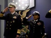 US Navy 080131-N-8273J-354 Adm. Gary Roughead, Chief of Naval Operations (CNO), and Yeoman 1st Class Tennille Hairston salute during the singing of the national anthem during a commissioning ceremony in the Hall of Heroes at th