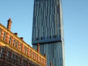 An image of the Beetham Tower in Manchester with a line of Deansgate stores in the foreground.