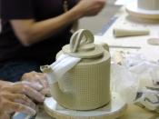 Ceramic teapot process: By moistening a strip of paper towel, and supporting the spout with the lid as shown you can prevent a wet spout from collapsing until it has time to firm up a bit