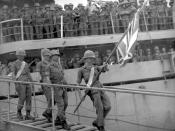 The Royal Thai flag is carried down gangplank of USS Okinagon.