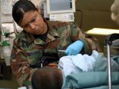 English: ATLANTIC OCEAN (Oct. 3, 2007) - U.S. National Guard Senior Airman Belitza Hernandez, attached to the post anesthesia care unit aboard Military Sealift Command hospital ship USNS Comfort (T-AH 20), helps a recovering patient after surgery. Comfort
