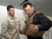 US Navy 110819-N-UU879-115 A Marine helps a Singapore Navy Military Expert with his flak jacket