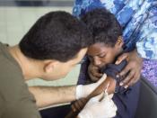 English: A Somali boy receives a polio vaccination at the Tunisian hospital in Mogadishu. The hospital treats local diseases, malnutrition, and other injuries.