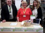 Roderick Campbell MSP and Anna Matthews, Barnardo's Works, join a volunteer at the shop