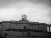 Swastika blasted from the Nazi party rally grounds in Nuremberg in 1945. Clips used are from a public domain biopic on Hitler, titled 