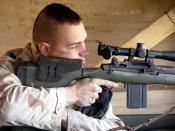 US Marine Corps Designated Marksman, armed with the Designated Marksman Rifle (DMR), derived from an M14 rifle with a telescopic sight.