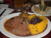 Typical Cuban dinner consisting of ropa vieja (shredded flank steak in a tomato sauce base), black beans, white rice, plantains and fried yucca.