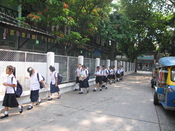 English: In Bangkok, these students were returning from their lunch break. Their school was next to a temple that we were visiting.