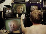 Lukas uses several television sets to absorb as many Holocaust survivor testimonies as possible. The people seen are actual Holocaust survivors.