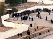 Hundreds of voters line up outside a polling place in Baghdad, 30 January 2005