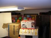 Practical jokes where balloons have been fitted between a door and a tower of boxes.
