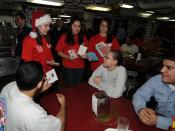 English: YOKOSUKA, Japan (Dec. 22, 2008) Volunteers from the National Honor Society at Kinnick High School pass out Christmas cards to the crew of the aircraft carrier USS George Washington (CVN 73). The cards were donated to the Red Cross from high schoo