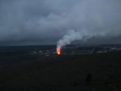 Sulfur dioxide emissions from the Halema`uma`u vent, Kīlauea glows at night.