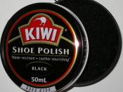 An open can of shoe polish with a side-mounted opening mechanism visible at the top of the photo