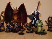 Several Dungeons & Dragons miniature figures. The grid mat underneath uses one-inch squares.