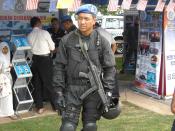 English: Officer from the UNGERIN, Royal Malaysian Police, on patrol at Taman Emas, Muar City during a exhibitions for the Community Policing. He belongs to the earlier batches of high-visible patrols by the UNGERIN, and dons the new sky blue beret togeth