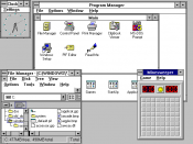 A Windows for Workgroups 3.11 desktop, which uses a stacking window manager.
